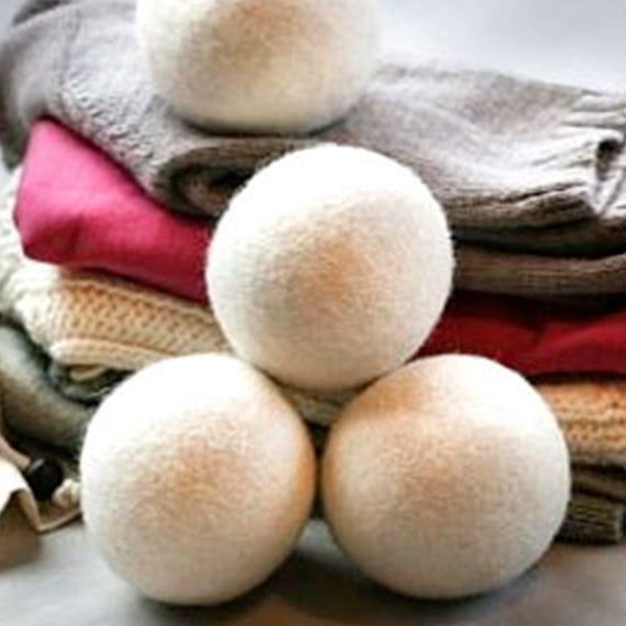 four NZ Wool Dryer Balls on cotton bag