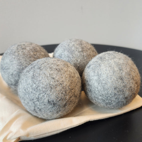 four NZ Wool Dryer Balls on cotton bag